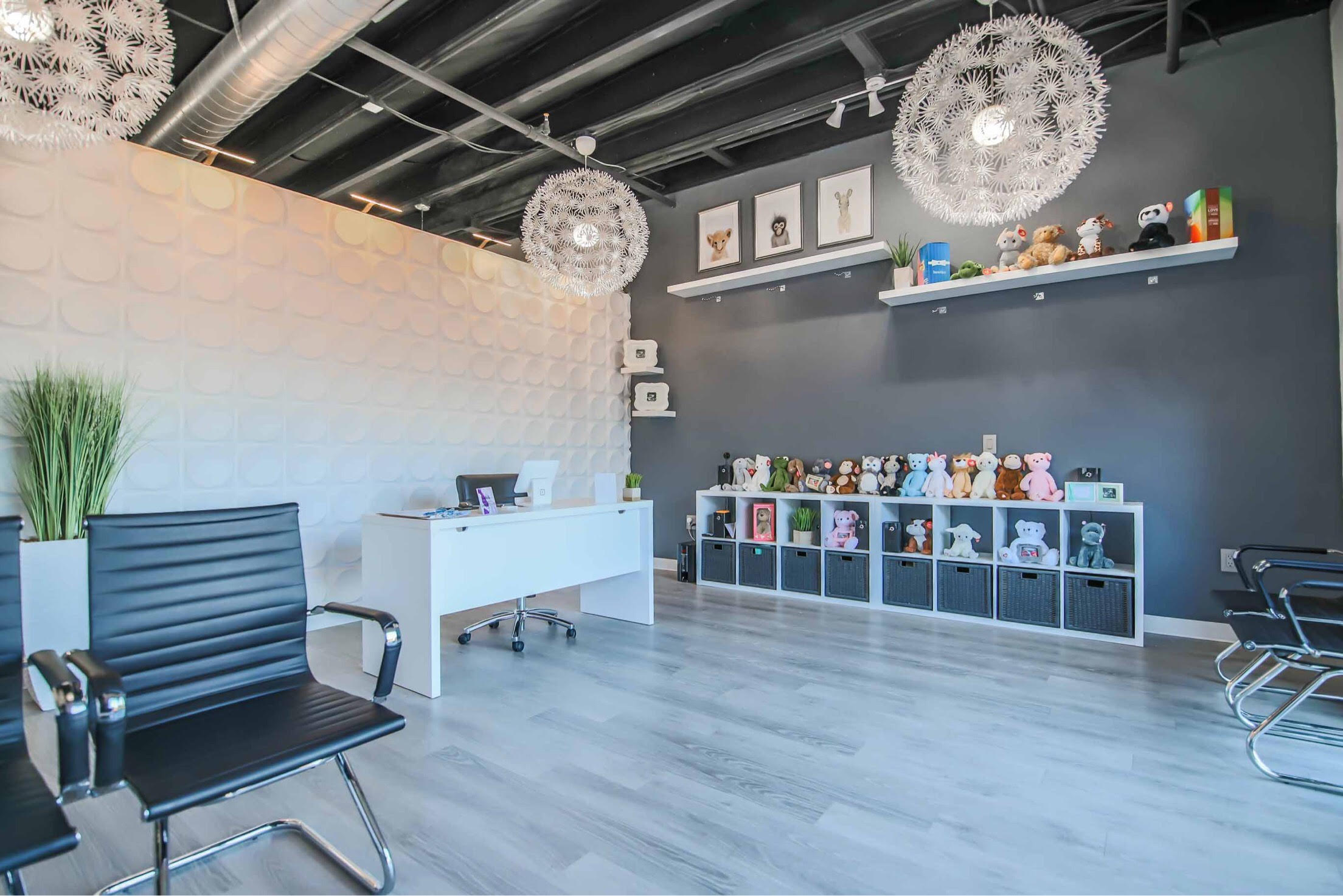 Sneak A Baby Peek studio interior with family seating and heartbeat keepsakes.